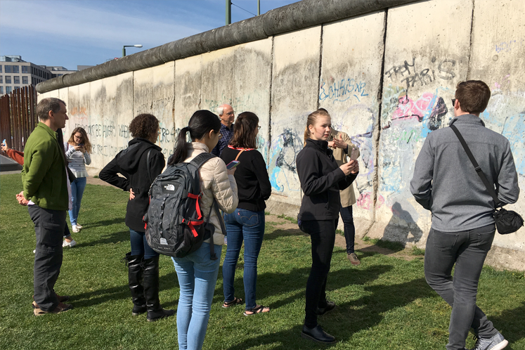 Students stand near the remnants of the Berlin Wall.